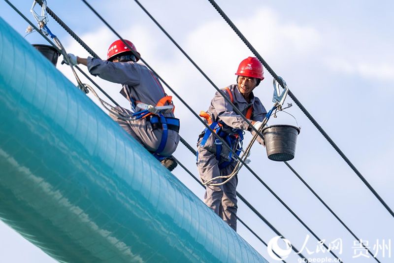 建设工人正在进行涂装作业。人民网记者 涂敏摄